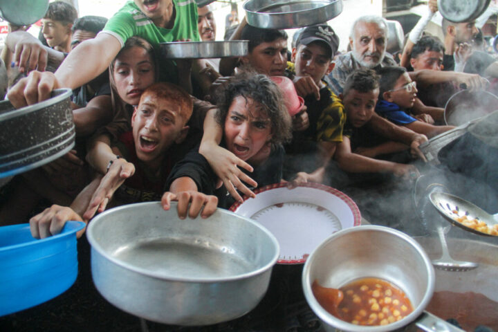 palestinians gather to receive food cooked by a charity kitchen, amid the israel hamas conflict, in the northern gaza strip